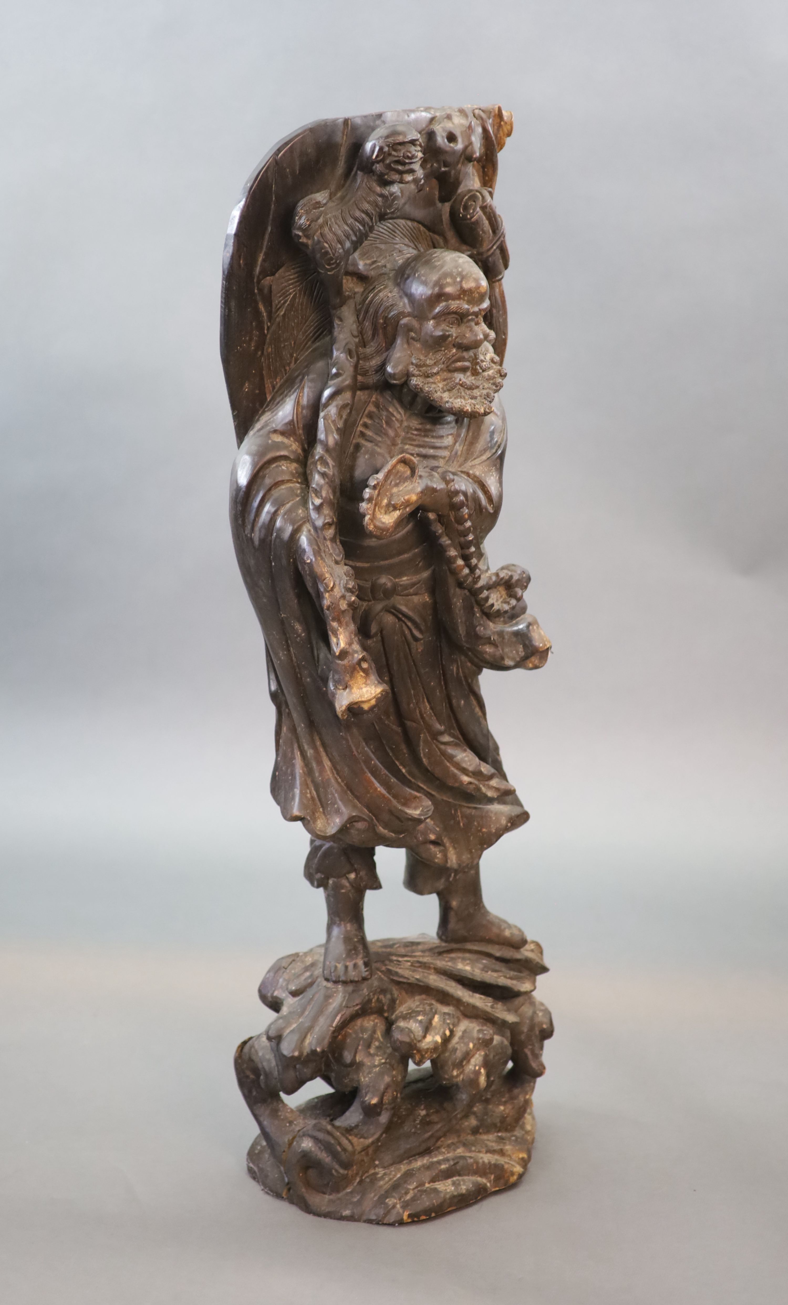 An early 20th Chinese carved hardwood figure of a Luohan